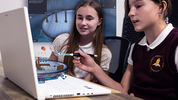 Two students using a zSpace laptop with augmented reality technology. The students are interacting with a 3D model of a scientific experiment displayed on the laptop screen using styluses. The AR model includes various scientific elements, such as molecules and structures, enhancing the learning experience.