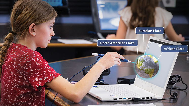 Student uses a stylus to interact with a 3D model of Earth on a zSpace laptop, identifying tectonic plates like the North American Plate, Eurasian Plate, and African Plate.