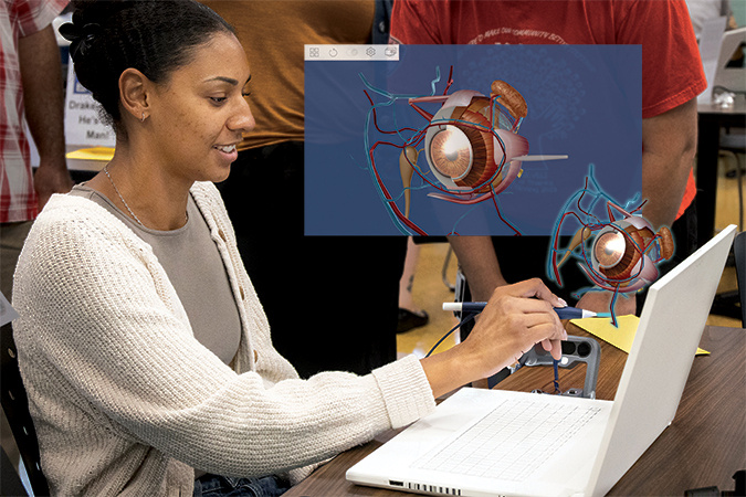 Person interacting with a zSpace laptop using a stylus to manipulate a 3D anatomical model of an eye. This immersive educational technology showcases zSpace's AR capabilities for detailed anatomy studies.